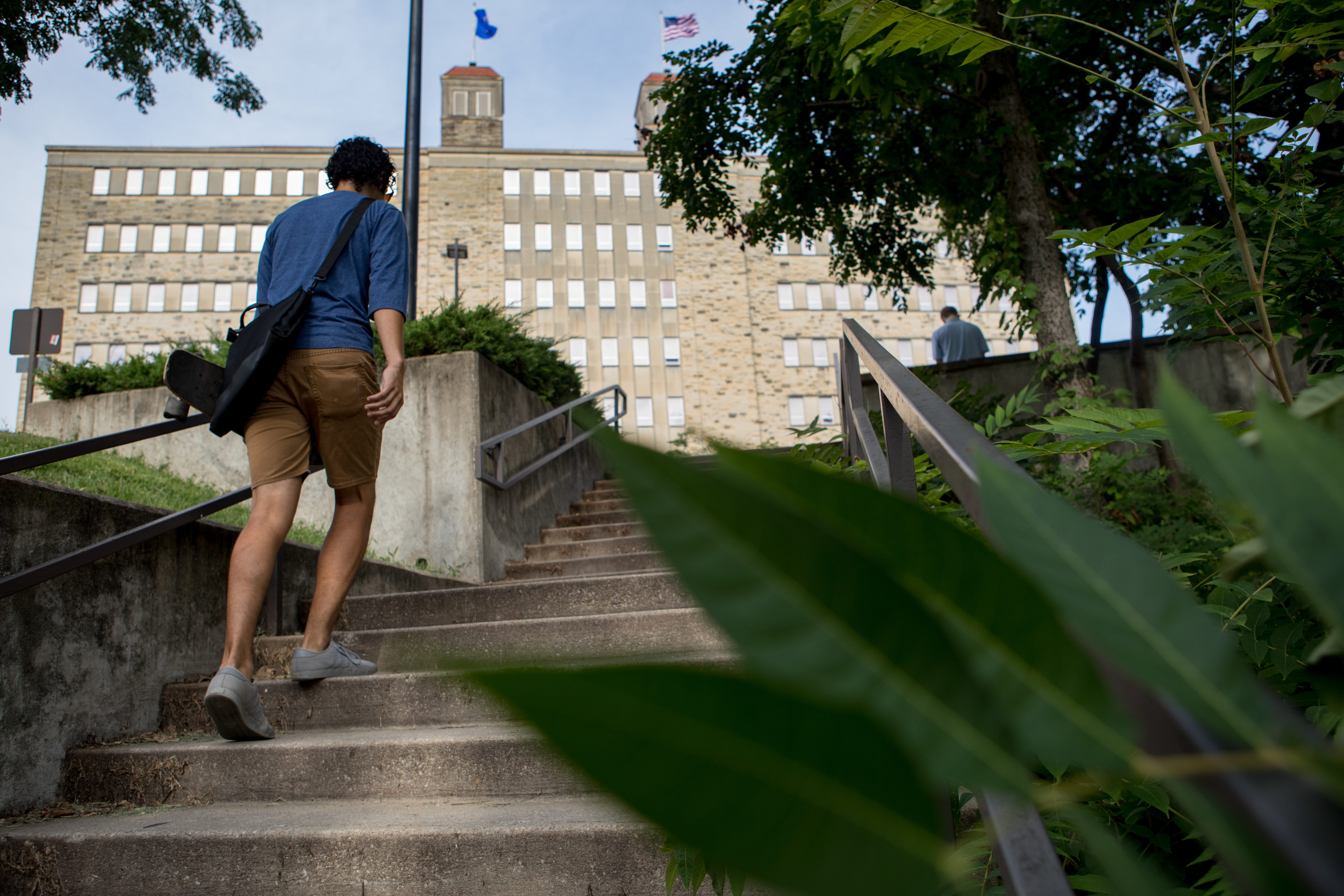 Student walking up stairs behind Fraser Hall