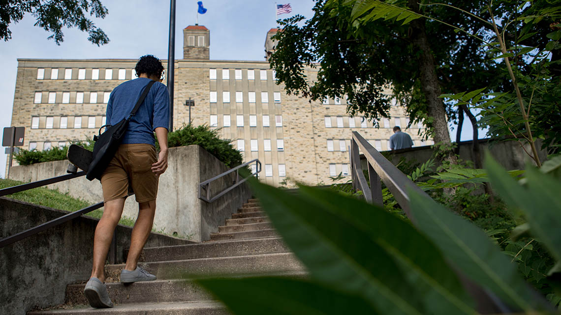 students walking up steps behind fraser hall